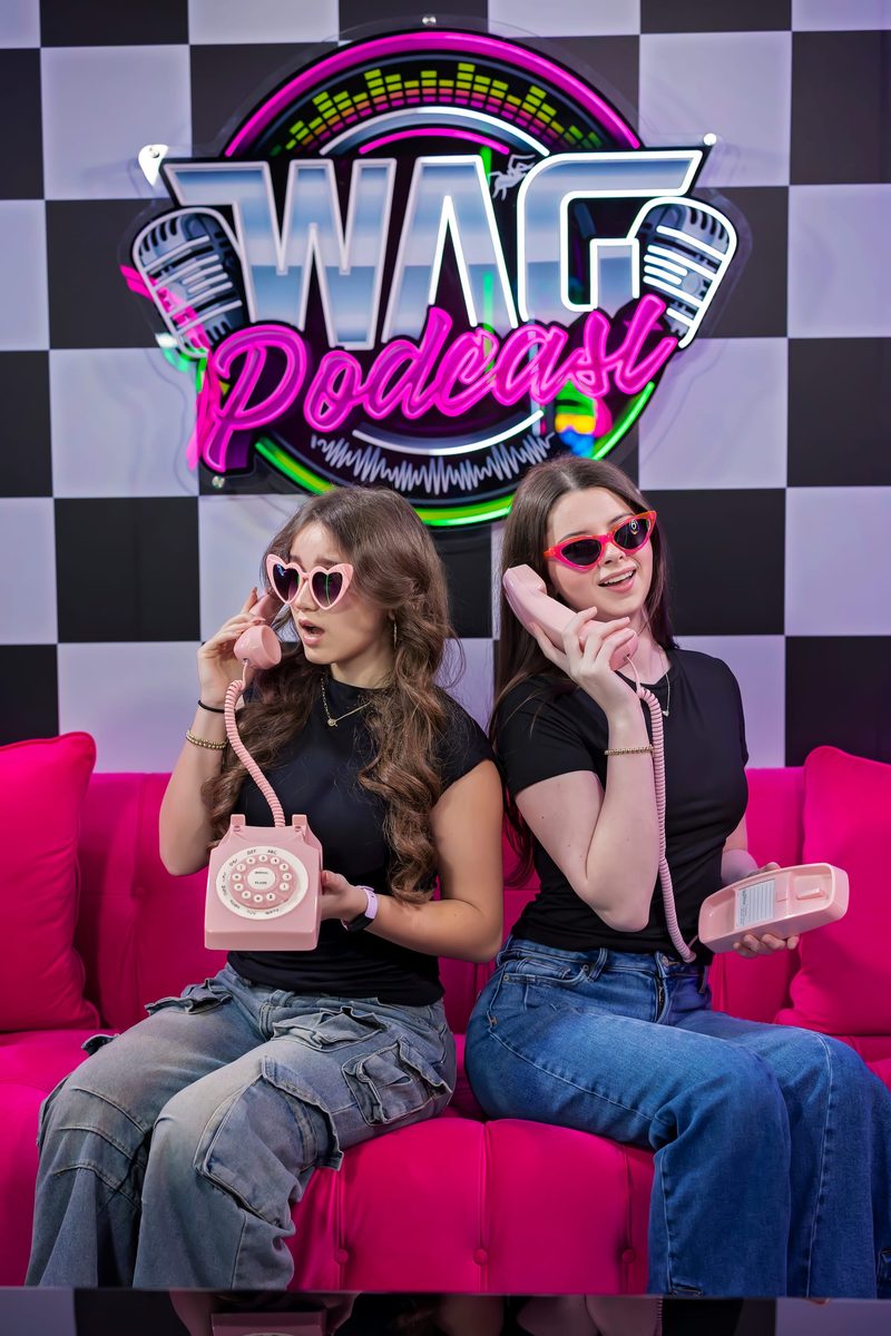 The real WAG Podcast set, checkerboard floor and neon sign